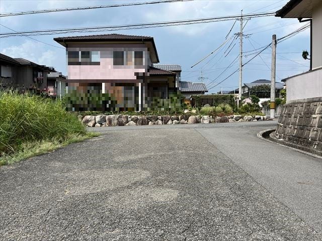 東側の前面道路です。車同士がすれ違うことのできる道幅です。停車中の車を追い越すこともできます。(2025年8月26日 撮影)