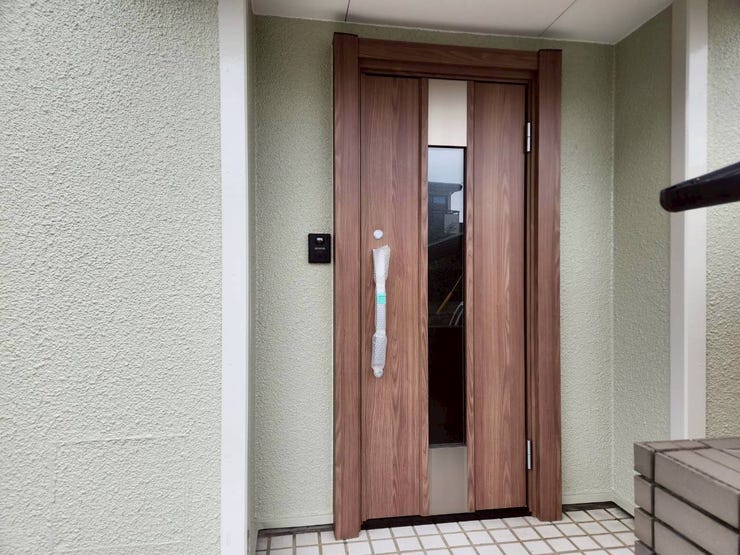 木目調のドアが外壁の色と調和し温もりを感じます。