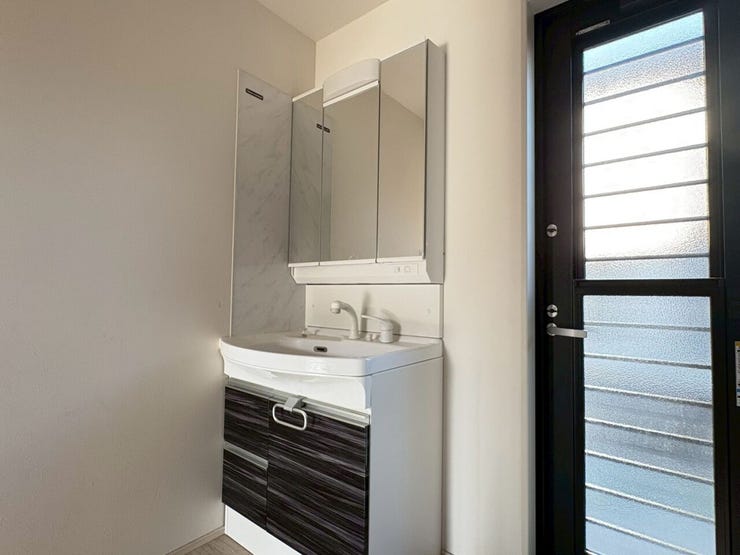 【現況販売】洗面所です。洗面所と浴室の間にはランドリールームも備わっているため、入浴中も洗面所へ出入りでき便利です。