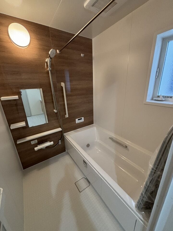 ウッド調のアクセントパネルが美しいバスルーム