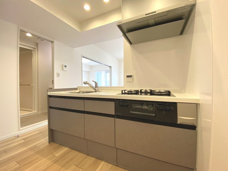 対面式のシステムキッチン。同時料理が可能な三口コンロや浄水機能付き水栓を完備しております。