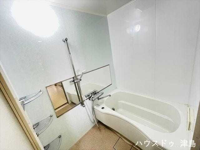 清潔感がある浴室です。大きな鏡が設置され、毎日のボディチェックができます。収納ラックが3ヶ所取り付けられ、シャンプーやボディソープなど床置きせずに片付けられます。