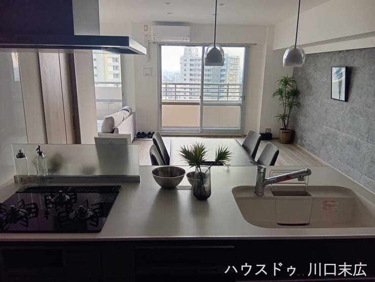 キッチンから望むリビングダイニング。開放感と壁面装飾のアクセントが調和する空間で、穏やかな時間を過ごせます。