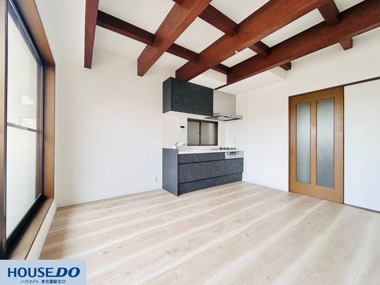 キッチンから室内全体を見渡せる、コミュニケーションの取りやすいレイアウトです。木の質感を生かしたフローリングと現しの梁が、空間に奥行きとリズムを与え、心地よい居場所を作り出しています。