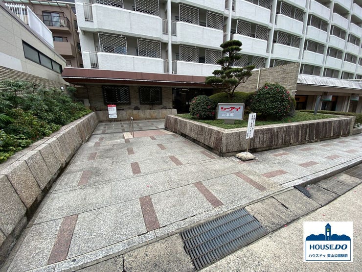 エントランスへ続く通路では、緑の木々が訪れる人々に癒しを与えます。