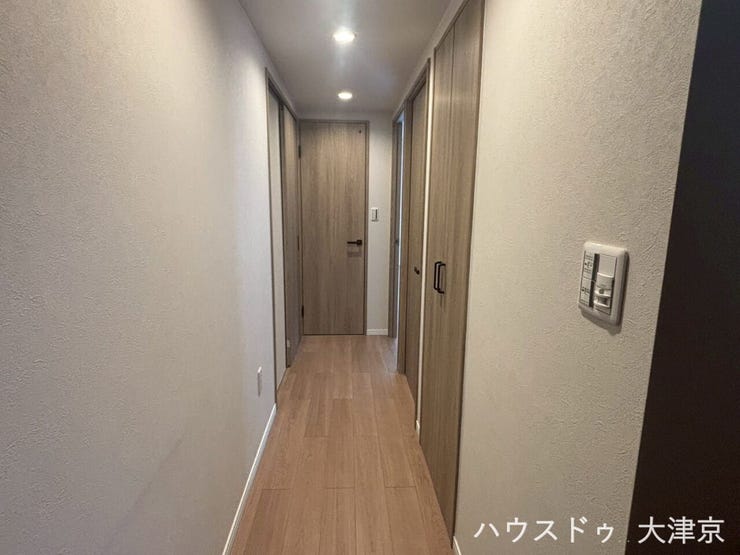 ダウンライトが導く上質な動線。洗練された木目調が彩る廊下。