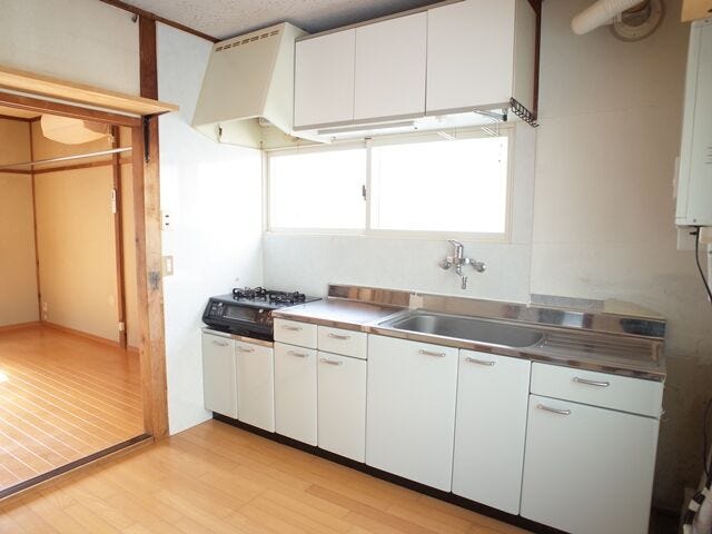 白基調の爽やかなシステムキッチン。吊戸棚下の小窓から光が入り、手元が明るく作業しやすいキッチンです。