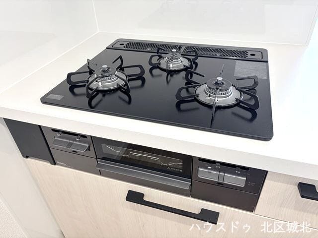 複数の調理を同時に進められる三口コンロと、便利なグリルを備えた機能的なキッチン。