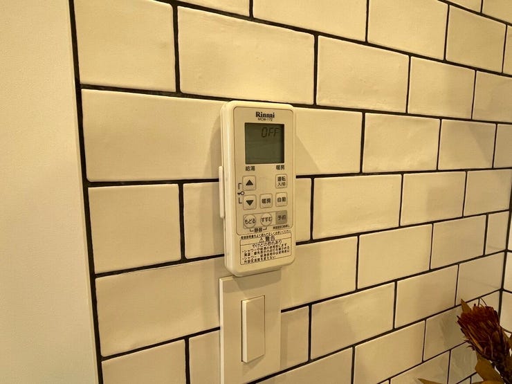 給湯器のリモコンは、キッチン壁面のタイルにすっきりと設置されています。手元で操作できるため、家事の合間にお風呂の準備や温度調整を済ませられて便利。日々の何気ない家事負担を軽減してくれる住まいです