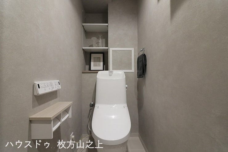 温水洗浄便座付きの清潔感あふれるトイレです。上部には収納棚を設けており、トイレットペーパーや掃除用品をすっきり収納できる使い勝手の良い空間です。