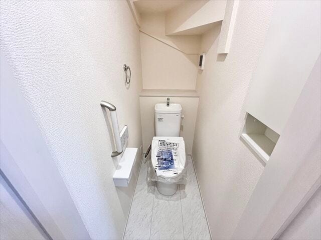 トイレ:ホワイトを基調とした清潔感のあるトイレです。ペーパーホルダーが2つあるのはうれしいですね。その上に小物を置くことができます。