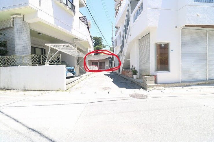 写真奥の建物が販売物件となります。