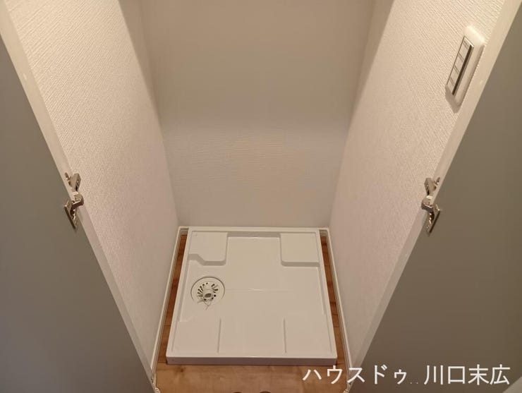 生活動線に配慮して配置された洗濯機置場。防水パンを備え付け、日々の家事をスムーズに行うための実用的なサニタリースペースです。