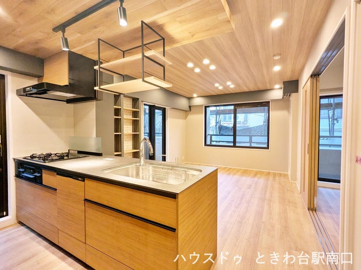 【ダイニングキッチン】
木目調の天井とアイランドキッチンが調和した、開放的なリビングダイニングです。落ち着いた配色がお洒落な空間を演出します。