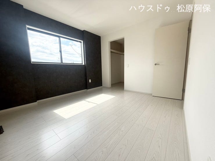 「シックなアクセントクロスが落ち着きを演出する主寝室。奥には便利なウォークインクローゼット付き。」