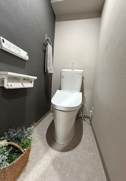 手洗い一体型の温水洗浄便座を採用。壁掛けリモコンやカウンターを備え、使い勝手にも配慮したトイレ