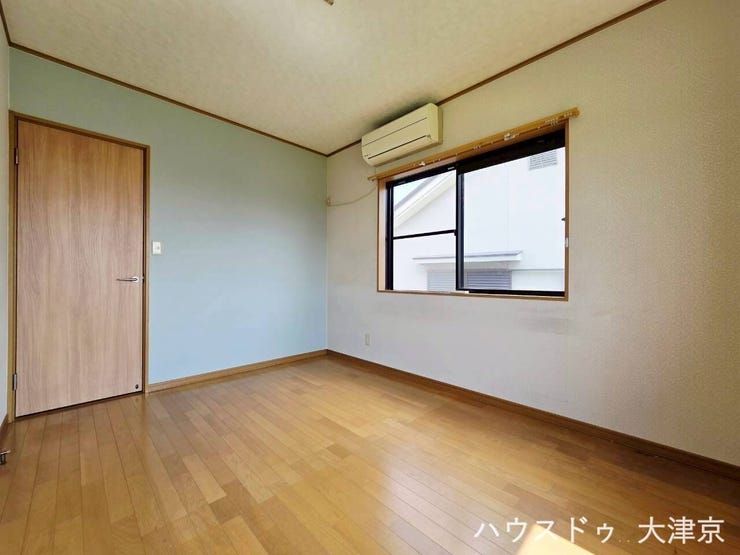 淡いブルーのアクセントクロスが爽やかな洋室。自然光が注ぐ心地よいインテリア空間です。
