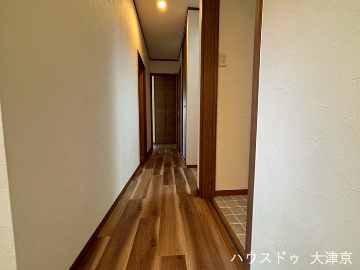 温かみのある木目調フローリングと優しい照明。各部屋へスムーズに移動できる機能的な廊下です。