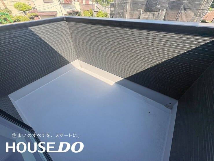 バルコニーの床と外壁のカット。黒いタイル調外壁とホワイトの床で見た目のコントラストが綺麗です。