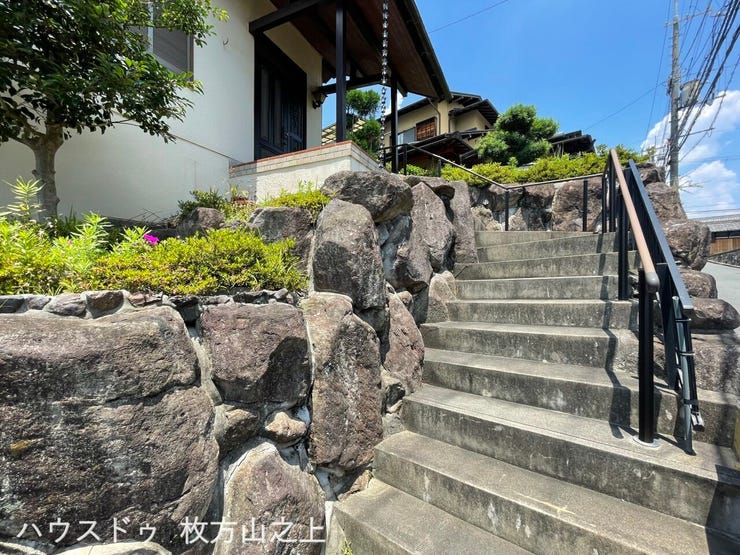 石積みと植栽が印象的な玄関アプローチ。住まいに趣を添える外構です。