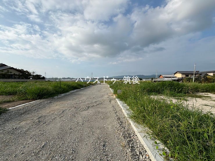 分譲地入口側を撮影。幅員約6.1mの道路で、車の出入りにもゆとりがあります。